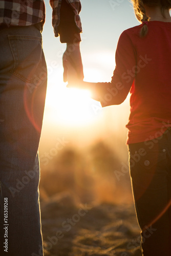 Father daughter holding hands at golden hour