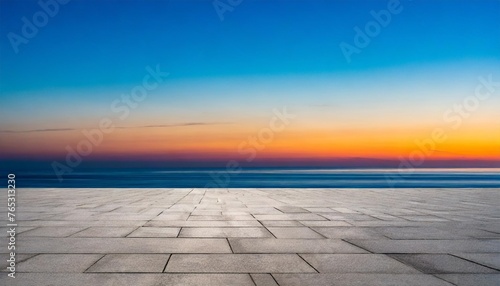 empty concrete floor against the backdrop of the ocean at sunset