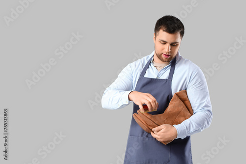 Male shoemaker brushing boo...
