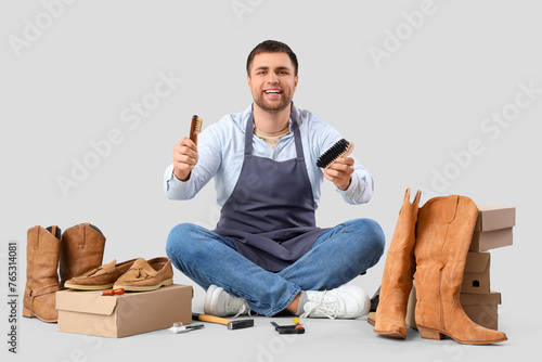 Male shoemaker with brushes...