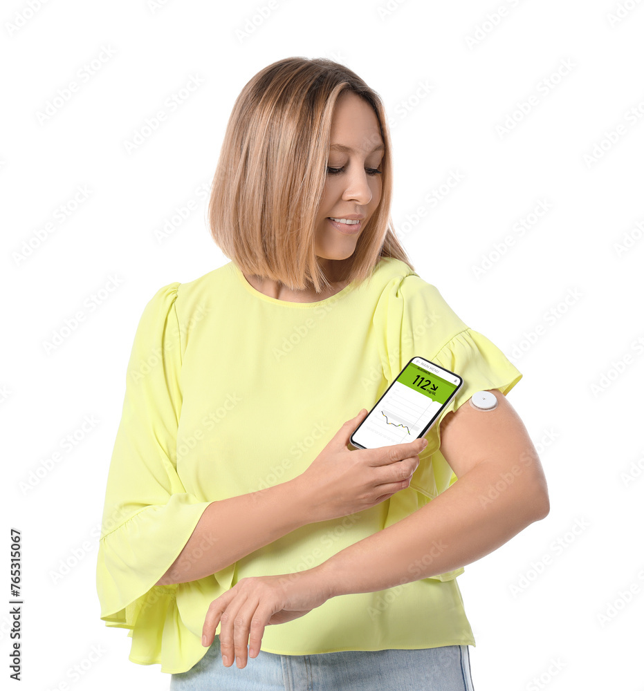 Diabetic woman with glucose sensor using mobile phone for measuring blood sugar level on white background Diabetic woman with glucose sensor using mobile phone for measuring blood sugar level on white background