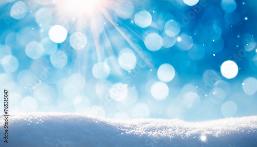 winter snow background with snowdrifts with beautiful light and snow flakes on the blue sky beautiful bokeh circles banner format copy space © Josue
