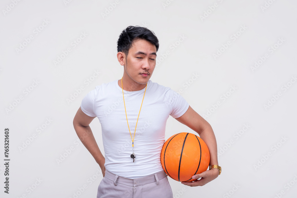 Depressed Asian man with basketball standing isolated on white