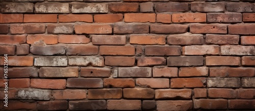 A detailed closeup of a brown brick wall showcasing the craftsmanship of the bricklayer. The rectangular bricks are set in mortar to form a sturdy building material