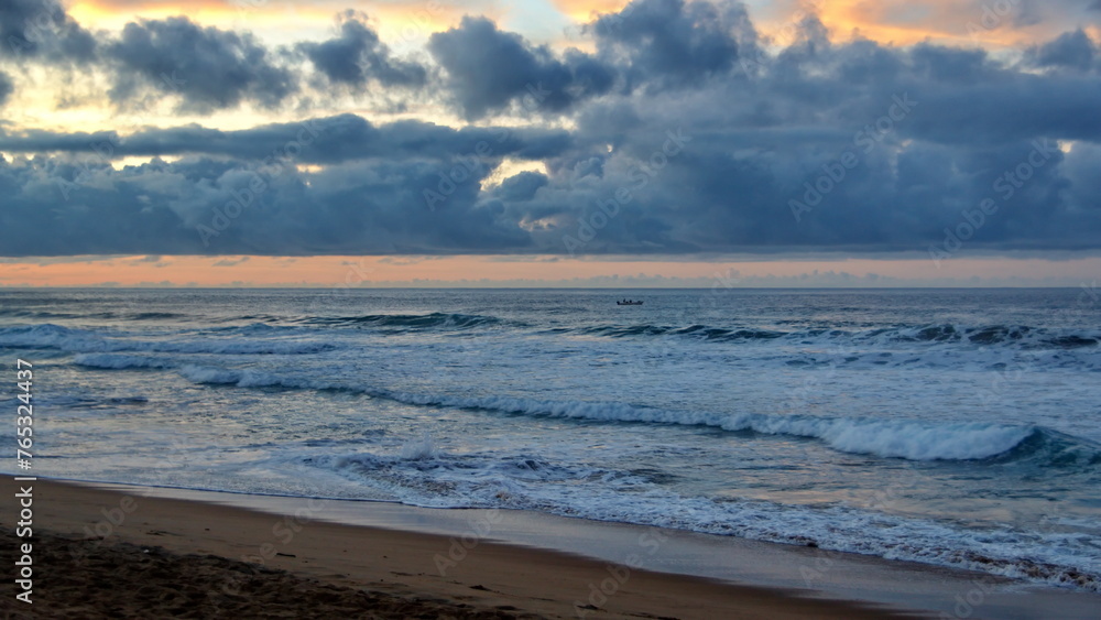 Waves breaking on the beach at sunrise, in Zipolite, Mexico