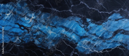 The image captures a detailed view of a blue marble slab against a solid black background, emphasizing its unique texture and color.