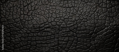 A detailed close-up view of a textured black leather surface with a unique pattern