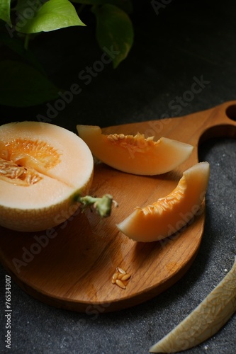 Melon slices on wooden board 