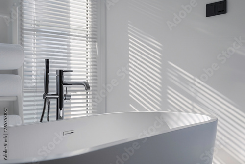 Stylish bathtub in modern style  modern bathtub near white wall in bathroom interior