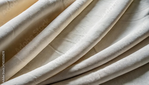 close up of thick white or beige draped cloth texile or fabric fashion background frame filling photo
