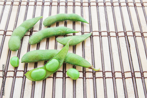 Fresh green soybeans on wooden background photo