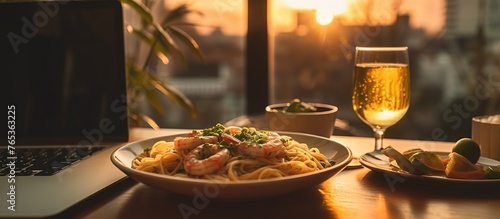 A plate of pasta with shrimp and vegetables is served with a glass of white wine