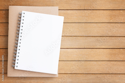 Blank paper notebook on brown wooden table
