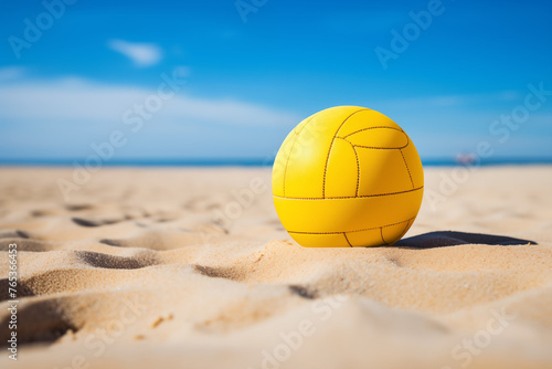 Closeup the yellow volleyball on the sandy beach