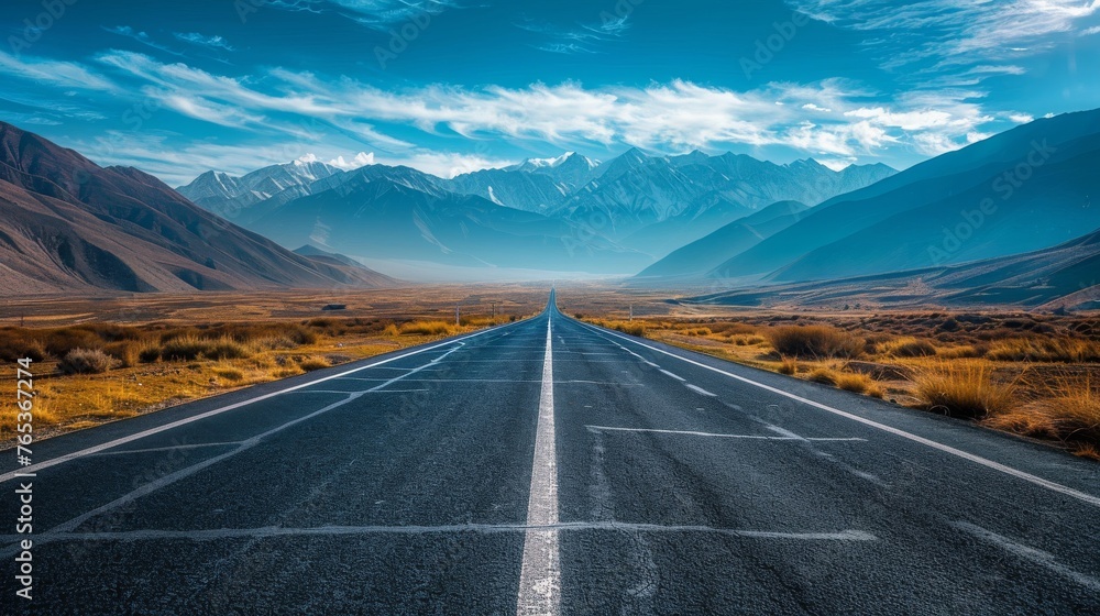 A road leading towards a distant mountain range,  symbolizing the ambitious goals and aspirations of startups