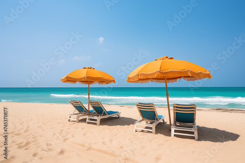 Colorful beach umbrellas, sun lounger, against the backdrop of a clear blue sky, golden sands. Beach travel summer holiday vacation concept  © h3bs