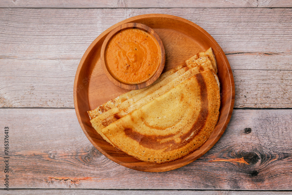 South Indian food set dosa with tomato chutney. Also called nice set dosa. Homemade Dosa, dhosa, masala, plain, maisuri (Ghee Roast) with Chutney. Common Indian breakfast.