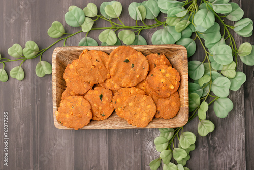 Thattai or Nippattu or Chekkalu is a south Indian deep fried snack made with rice flour prepared during festive and daily common snack.  Thattai is a south Indian fried snack, Spicy and Crispy photo