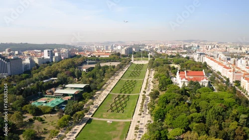 Aerial Shot Of Famous Parque Eduardo Vii In Residential City Against Sky, Drone Flying Forward On Sunny Day - Lisbon, Portugal