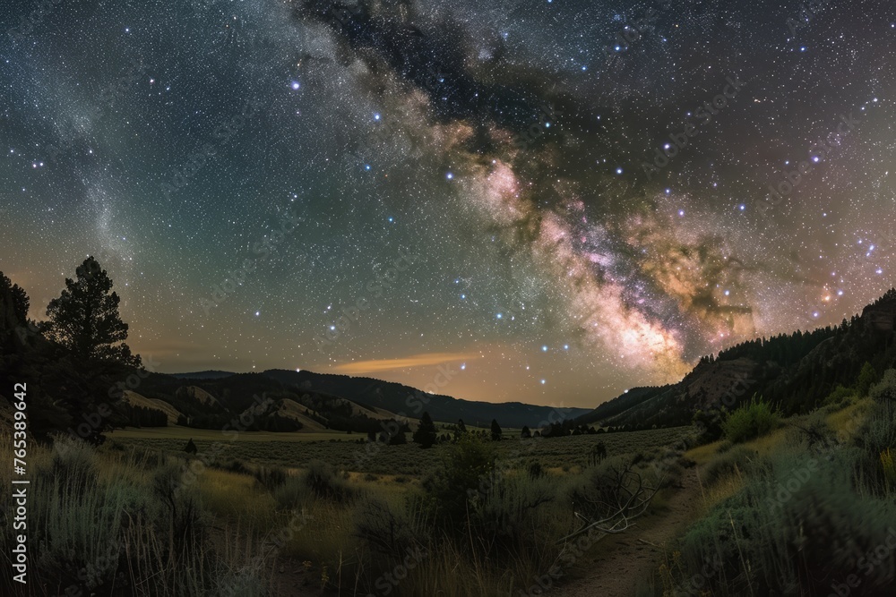 A night sky filled with numerous stars above untouched terrain in a remote landscape