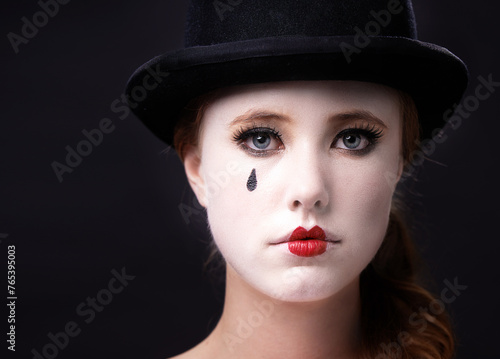 Portrait, woman and circus performer in studio on white background with creative makeup for entertainment, artist and mime. Face, female person and career with hat for performance or rehearsal © Tasneem/peopleimages.com