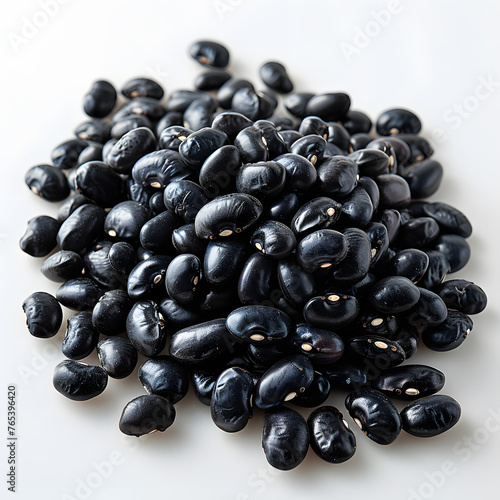 A pile of black beans  a superfood ingredient in natural foods  sits on a white surface resembling automotive tires. This produce can be used in various recipes and dishes