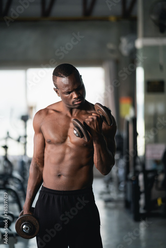 African sport man using dumbbell exercise at gym. Asian body building for muscle training. Sport health gym concept