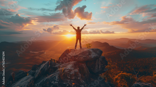 Winning and sport concept  Male Hiker celebrating success on top of a mountain