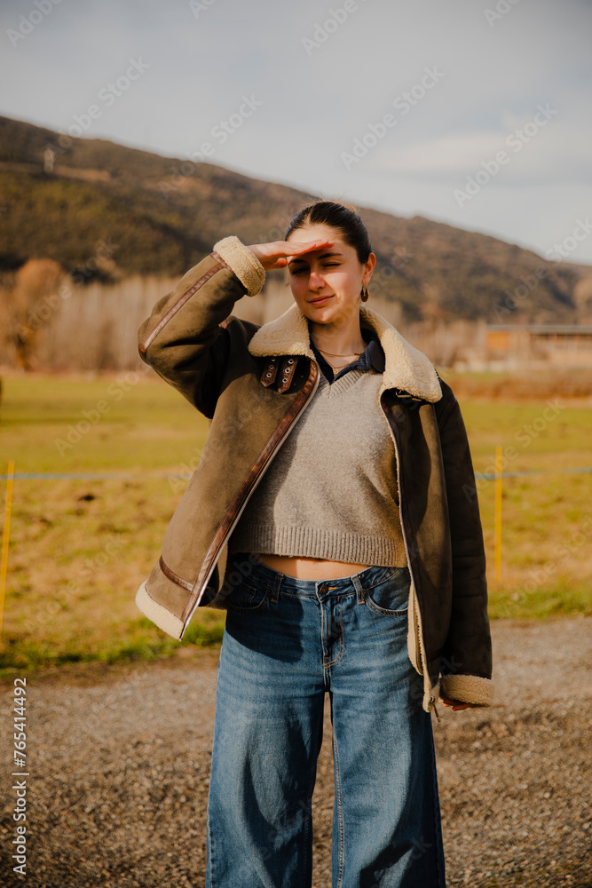 Girl in Jacket and Wide Pants in Mountains looking at camera Girl in Jacket and Wide Pants in Mountains looking at camera