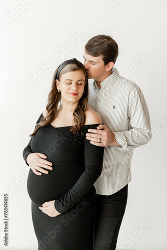 Couple in loving maternity embrace, savoring the moment