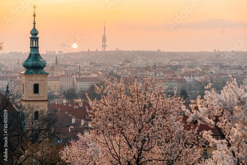 Pink flowering tree branches and red roofs at dawn in Prague photo