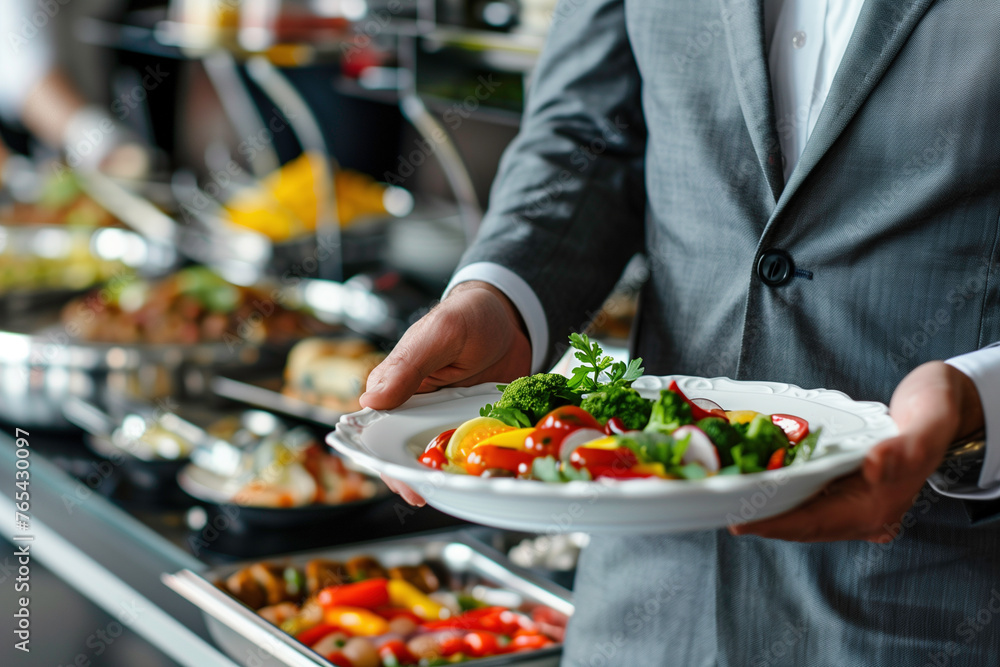 Close up of man holding food portion at buffet event