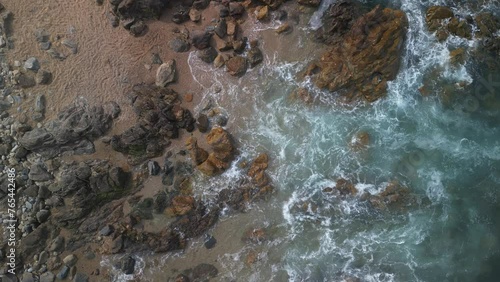 Drone shot of the Atlantic Ocean waves crashing on rocks on Matosinhos Beach in Porto city, Portugal photo