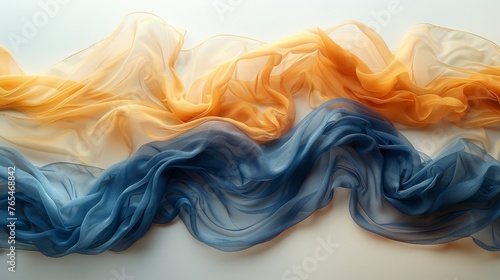 Image displays a graceful arrangement of blue and orange flowing fabrics on a light background