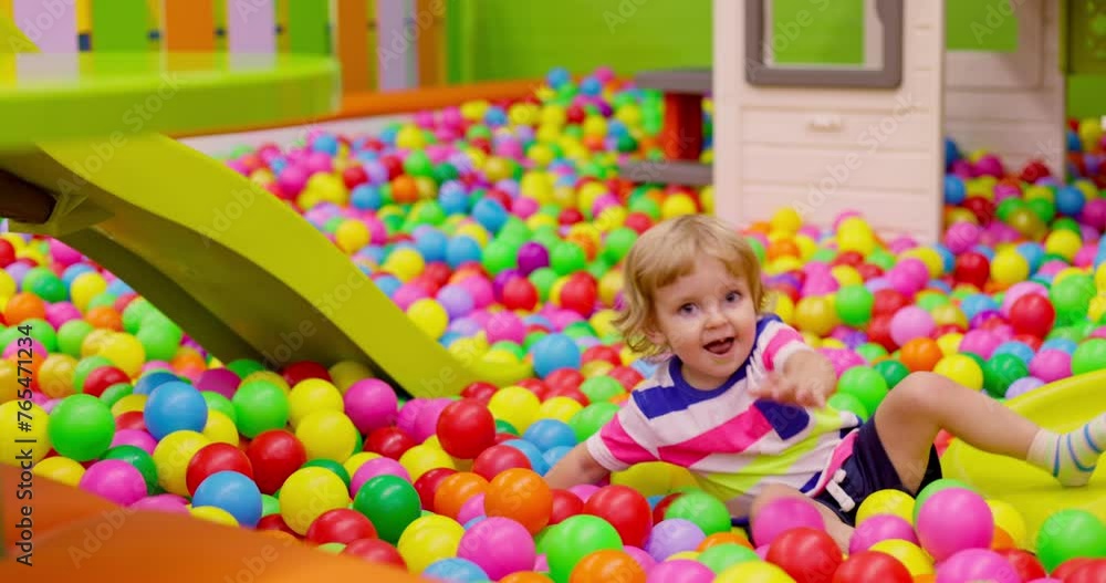 Toddler Sliding Down in Colorful Playroom Toddler Sliding Down in Colorful Playroom