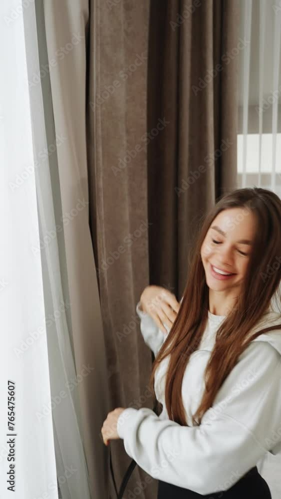 Two young women go on vacation. A woman checks into a hotel, laughs and takes a selfie. Vertical video Two young women go on vacation. A woman checks into a hotel, laughs and takes a selfie. Vertical video