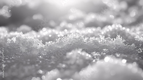 Close-up of sparkling snow crystals in soft focus  with a monochrome  grayscale palette.