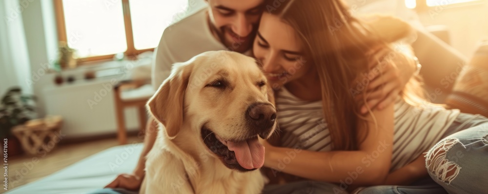 Couple sitting at sofa and play with their dog in livingroom Couple sitting at sofa and play with their dog in livingroom