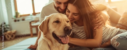 Couple sitting at sofa and play with their dog in livingroom