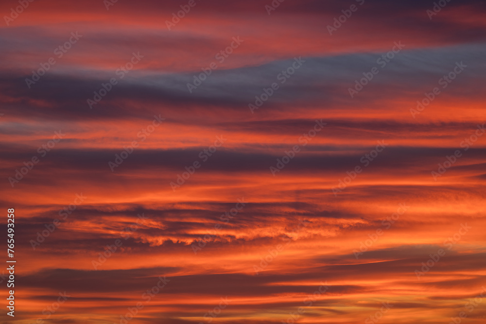 Dramatic sunset with vibrant clouds lit by a sun