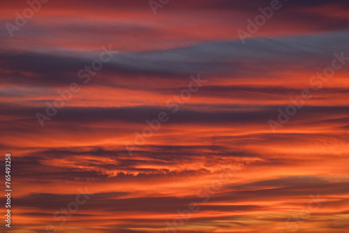 Fototapeta Naklejka Na Ścianę i Meble -  Dramatic sunset with vibrant clouds lit by a sun