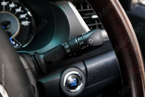 Switch off lights in a car. close-up Car integrated turning indicator with headlight switch toggle. 