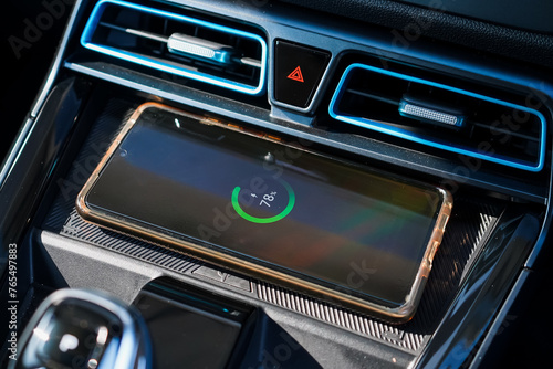 Wireless mobile charger in the modern car. Portable wireless car charger for smartphone.	