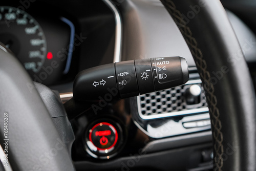 Switch off lights in a car. close-up Car integrated turning indicator with headlight switch toggle.	