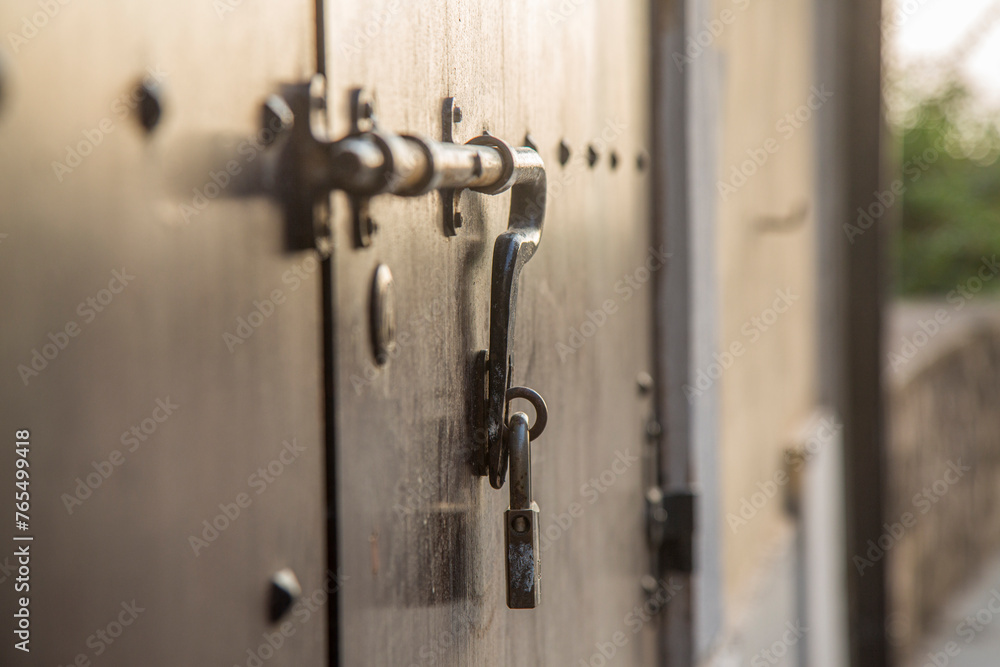 Old wooden doors with rings and old-fashioned vintage steel knocker handle close up in Italy.