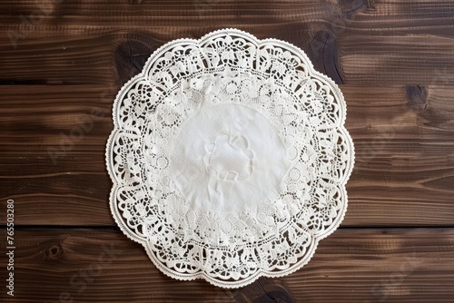 Round lace doily under cake with floral border pattern, circle lacy napkin.
