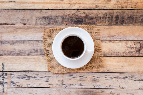 Cup of coffee on old wooden table background