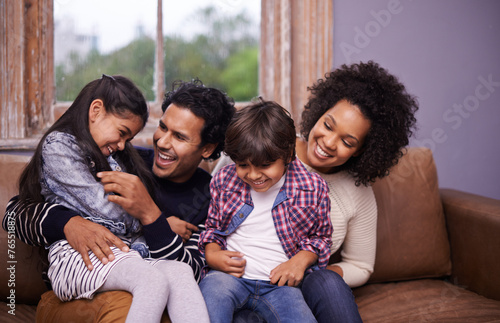 Parents  children and laughing on couch for playing connection for relax holiday  love or bonding. Man  woman and siblings for childhood trust for parenting support or comfort care  joke or happiness