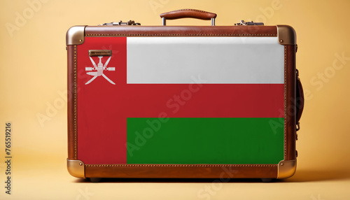 Oman flag on old vintage leather suitcase with national concept. Retro brown luggage with copy space text. photo