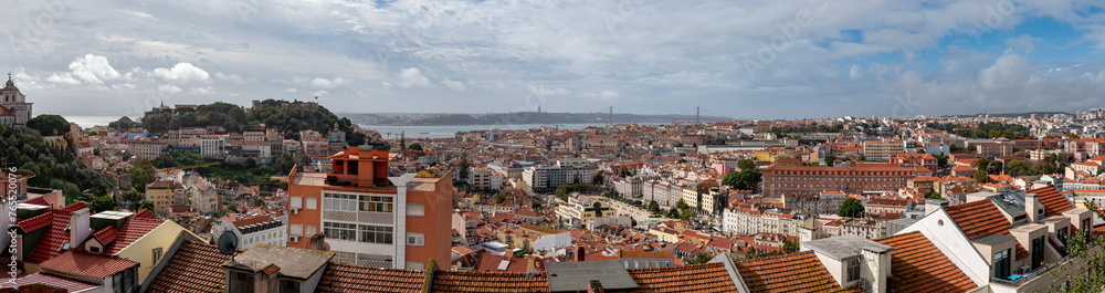 Panoramic view of the cityscape of Lisbon, Portugal, with Sao Jorge Castle and the red roofes of the Alfama district